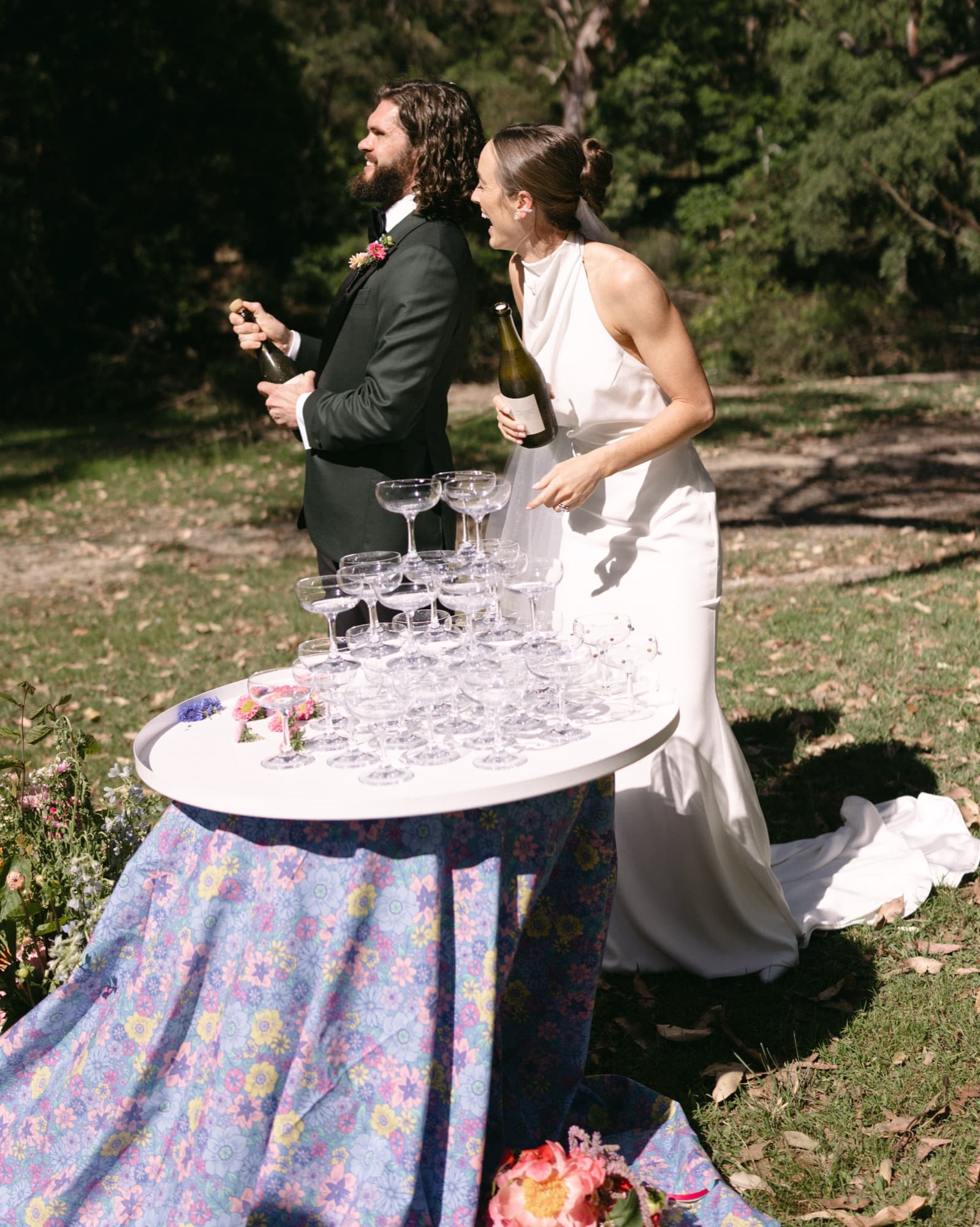 A couple celebrating with a champagne tower on their wedding day
