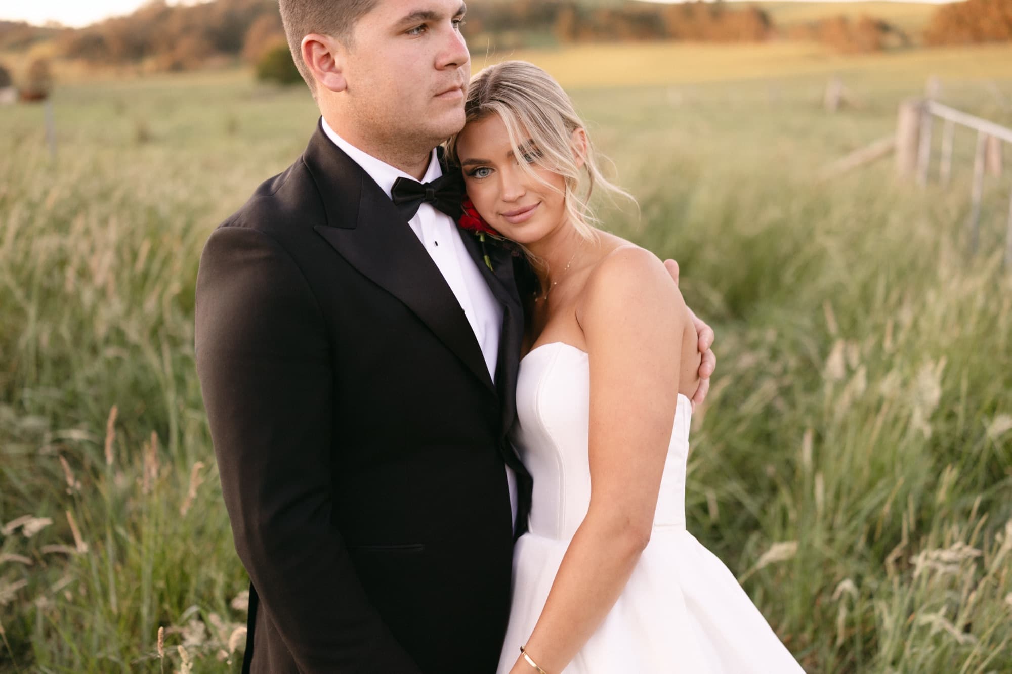 A wedding couple embracing at golden hour